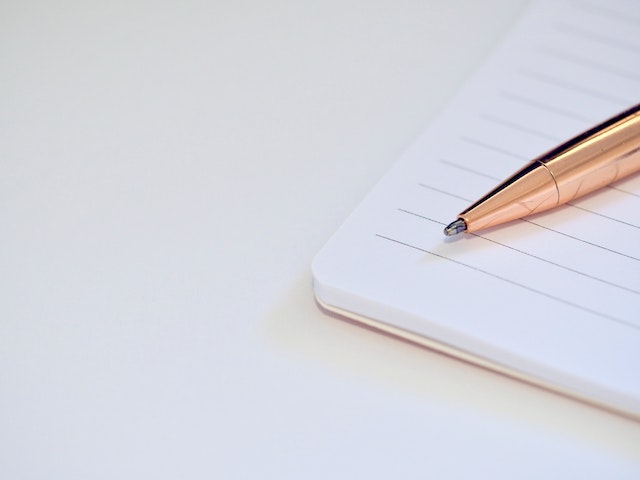 rose-colored-ballpoint-pen-on-a notebook.jpg